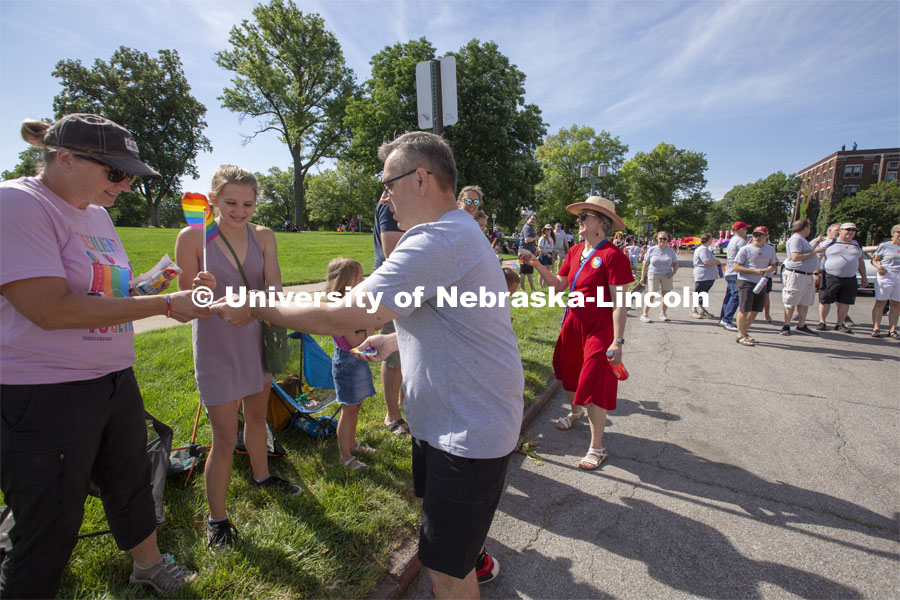 Chancellor Ronnie Green and his wife, Jane, hand out Husker Pride stickers along the Star City Pride parade route on June 19. Multiple university administrator participated in the event. Star City Pride parade on June 19, 2021. Photo by Troy Fedderson / University Communication